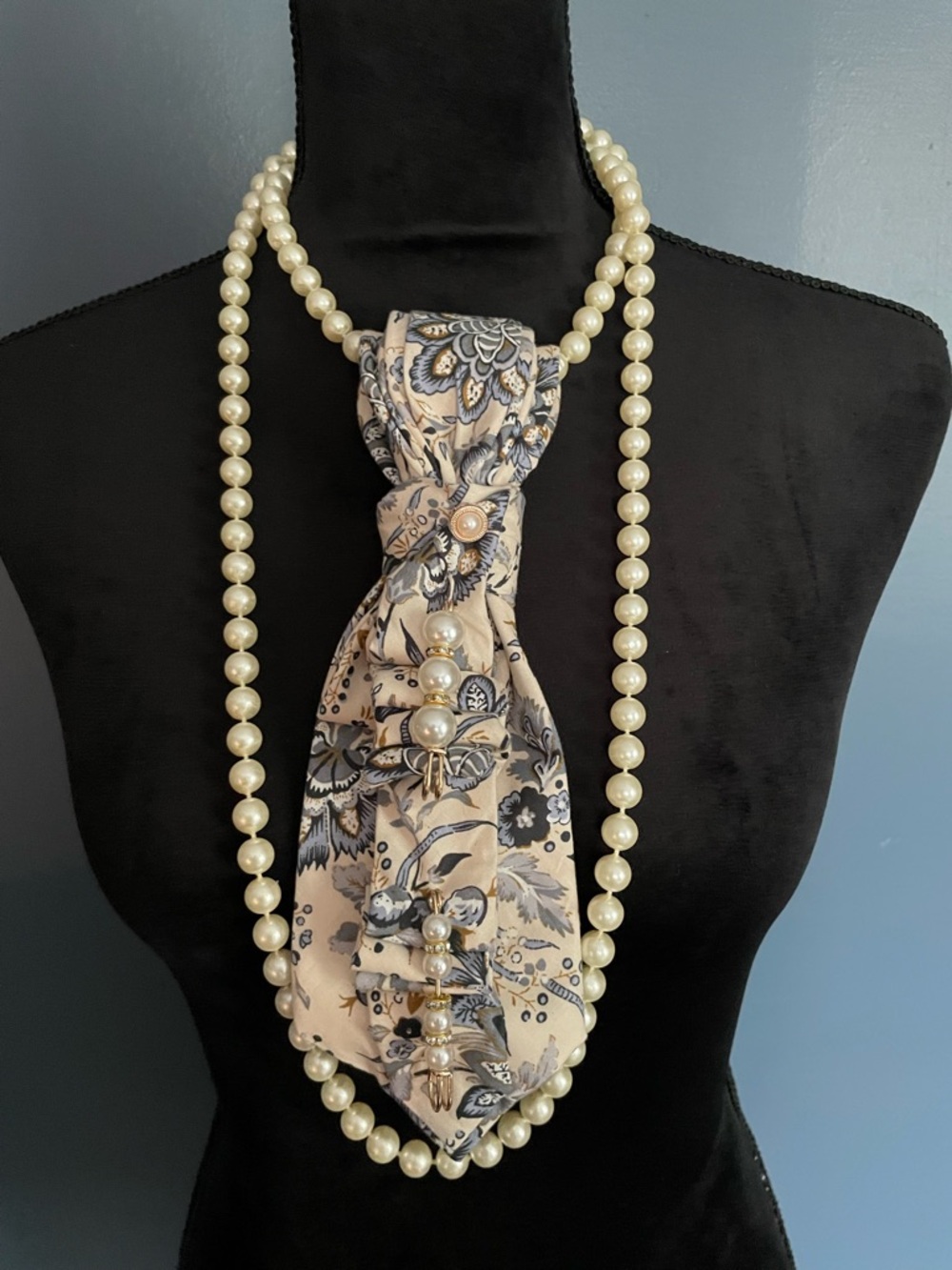 Floral Print Necktie with pearl necklace for layering.